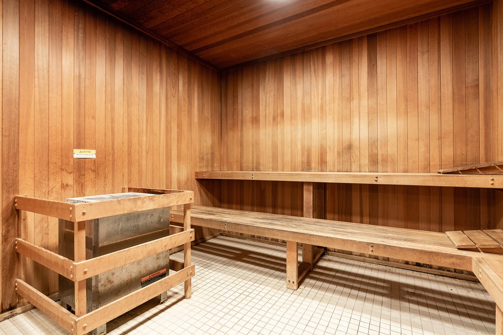 an empty sauna with wooden walls and benches